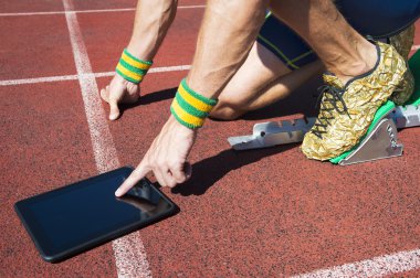 Athlete Using Tablet on the Track