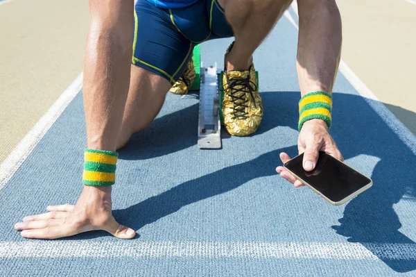 Atleta che utilizza il telefono cellulare in pista — Foto Stock