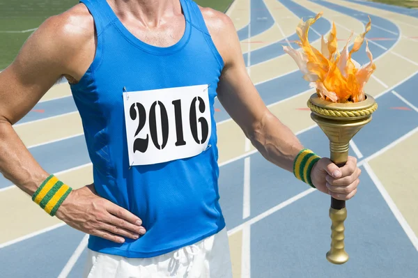 Track Athlete Wearing 2016 Race Bib Holding Torch – stockfoto