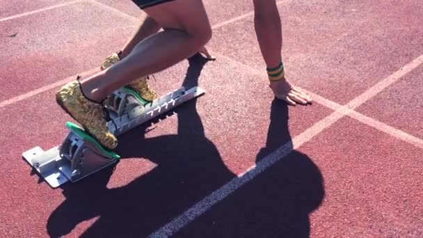 Athlete in Gold Shoes Sprinting Across Starting Line — Stock Video