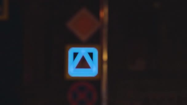Pedestrian crossing sign glowing in the dark city street — Stock Video