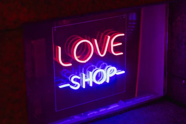 sex love shop neon sign showcase window glowing.concept sex shop advertisement toys adult