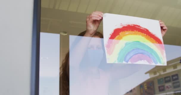 Schoolgirl Wearing Face Mask Glueing Rainbow Drawing Window Education Back — Stock Video