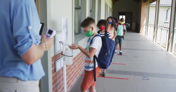 Grupo Multiétnico Escolares Con Máscaras Faciales Haciendo Cola Esperando Control — Vídeo de stock