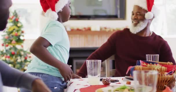 African American Boy Santa Hat Hugging His Grandfather While Sitting — Stock Video