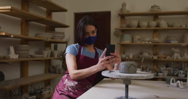 Female Caucasian Potter Wearing Face Mask Apron Taking Picture Pot — Stock Video