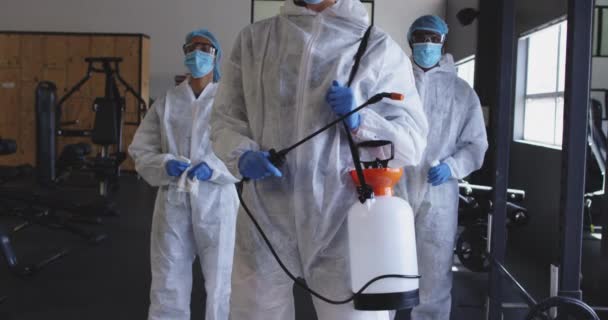 Team Health Workers Wearing Protective Clothes Holding Disinfectant Sprayer Gym — Stock Video