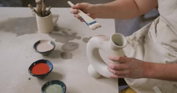 Mid Section Female Potter Wearing Apron Using Glaze Brush Paint — Stock Video