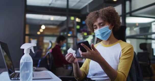 Afro Amerikaanse Vrouw Draagt Gezichtsmasker Schoonmaken Van Haar Smartphone Met — Stockvideo