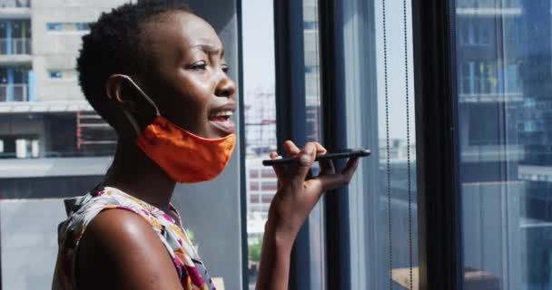 African American Woman Face Mask Her Neck Talking Smartphone Modern — Stock Video