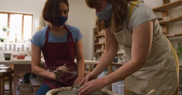 Two Female Caucasian Potters Wearing Face Masks Aprons Creating Pottery — Stock Video