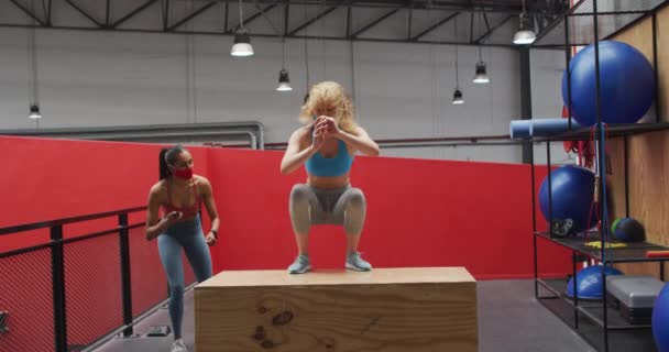 Caucasian Woman Jumping Box Wearing Face Mask Gym Mixed Race — Stock Video
