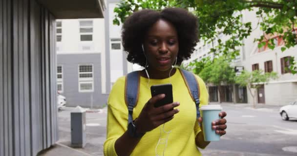 Afrikai amerikai nő használ okostelefon az utcán — Stock videók