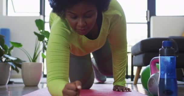 Afrika kökenli Amerikalı kadın vlogger egzersiz paspasına uzanmış çalışıyor. — Stok video