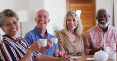 Masada oturup çay içen iki farklı son sınıf çifti. Kameraya bakıp gülümsüyor. Üst düzey emeklilik hayatı arkadaşları sosyalleşiyor.