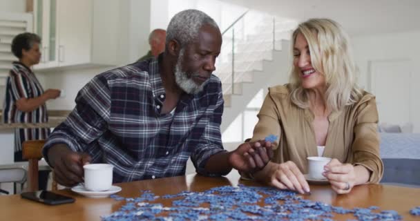 African American Senior Man Caucasian Senior Woman Sitting Table Doing — Stock Video