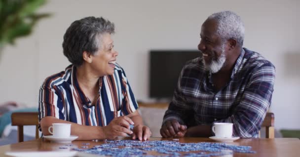 African American Senior Couple Sitting Table Doing Puzzles Drinking Tea — Stock Video