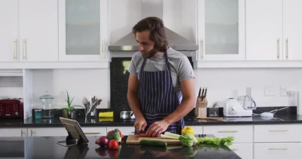 Mutfakta Dijital Tablete Bakarken Önlük Giymiş Sebze Doğrayan Beyaz Bir — Stok video