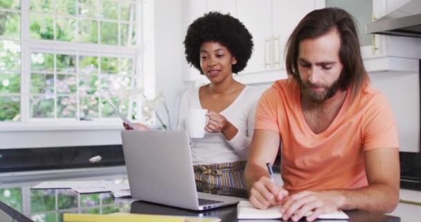 Happy Mixed Race Couple Using Laptop Calculating Finances Kitchen Home — Stock Video