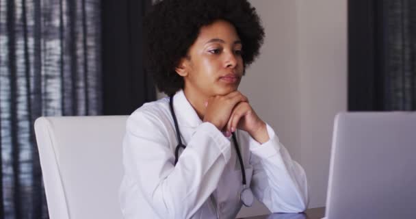 African American Female Doctor Having Videocall Laptop While Sitting Home — Stock Video