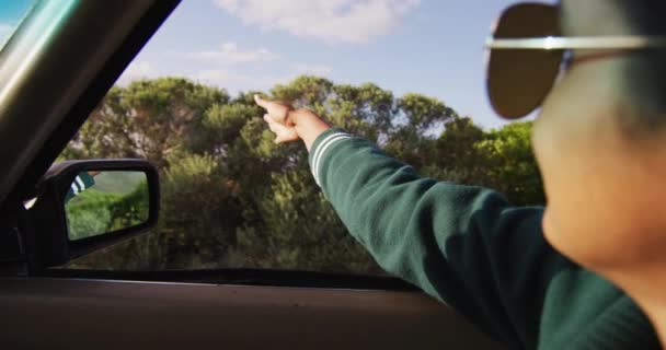 Mixed Race Woman Driving Sunny Day Convertible Car Waving Arm — Stock Video