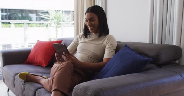 Mixed Race Gender Fluid Person Sitting Couch Using Tablet Home — Stock Video
