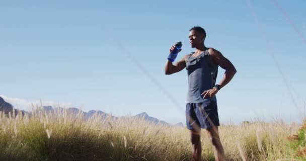 African American Man Exercising Outdoors Drinking Water Countryside Coast Fitness — 비디오