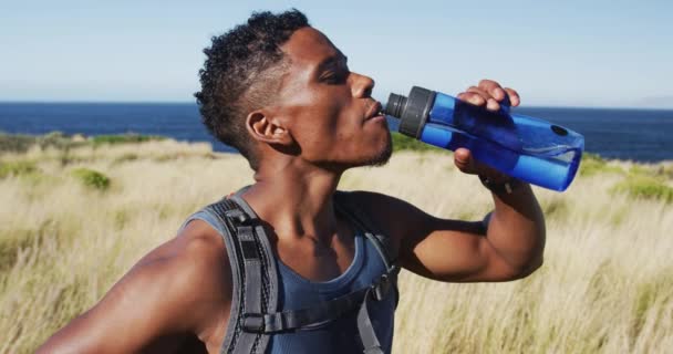 African American Man Exercising Outdoors Drinking Water Countryside Coast Fitness — Vídeos de Stock