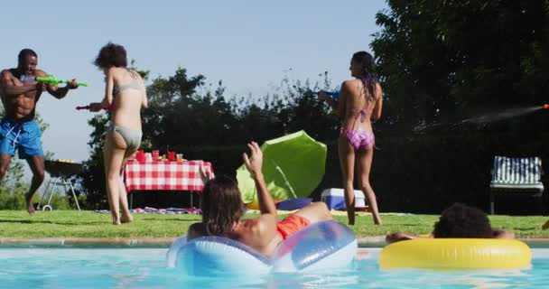 Mixed Race Woman Having Fun Playing Water Guns Swimming Pool — Stock Video