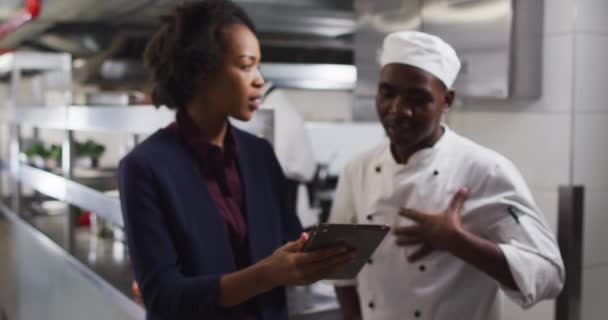 Africká Americká Manažerka Používá Tablet Mluví Šéfkuchařkou Práce Rušné Kuchyni — Stock video