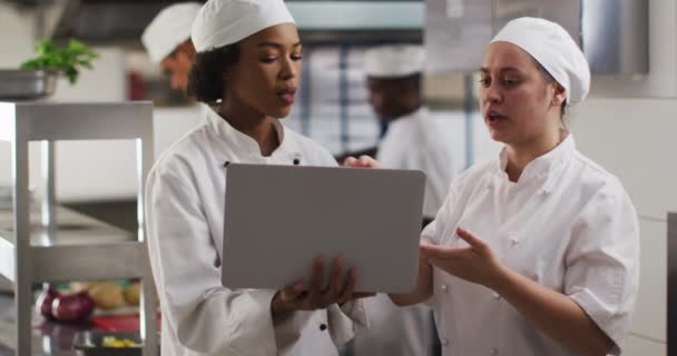 Two Diverse Female Chefs Talking Using Laptop Restaurant Kitchen Working — Stock Video