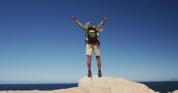 African American Man Hiking Mountains Standing Rock Raising His Hands — Stock Video