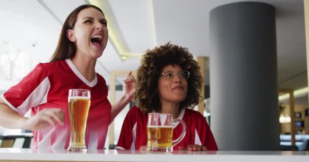 Diverso Grupo Amigos Felices Viendo Partido Bebiendo Cervezas Abrazándose Bar — Vídeo de stock