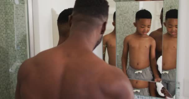 African American Father Son Flexing Muscles Mirror Together Staying Home — Stock Video