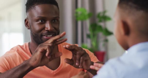 African American Father Teaching His Son Sign Language Staying Home — Stock Video