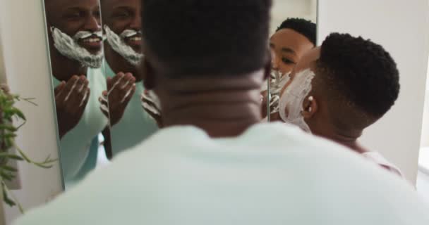 African American Father Son Putting Shaving Cream Faces Laughing Together — Stock Video