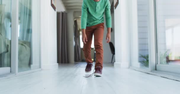 African American Boy Standing Hallway Tying His Shoes Staying Home — Stock Video