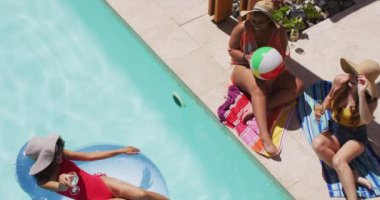 Çeşitli bayan arkadaşlar bilardo topunda eğleniyorlar. Bayan arkadaşlar birlikte vakit geçiriyorlar..