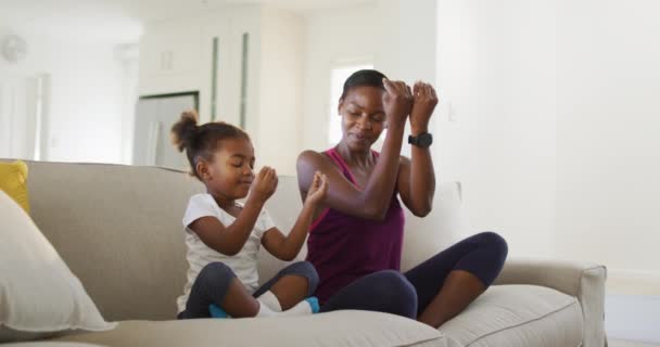 Happy African American Mother Daughter Sitting Sofa Doing Yoga Exercise — Stock Video