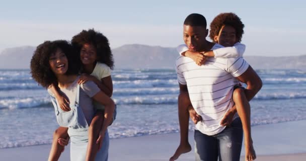 African American Mother Father Giving Piggyback Ride Daughter Son Beach — Stock Video