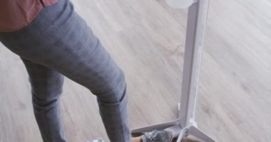 İş kadını, iş yerine girerken el dezenfekte etmek için ayak pompası dezenfektanı kullanıyor. Coronavirus covid 19 salgını sırasında modern bir ofiste bağımsız yaratıcı işler..