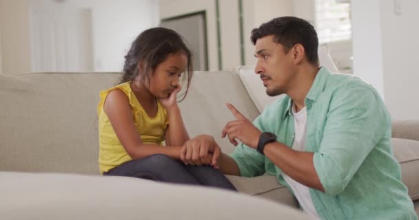 Hispanic Father Telling His Young Upset Daughter Sitting Sofa Home — Stock Video