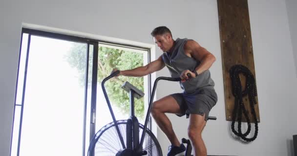 Fit Sweaty Caucasian Man Exercising Training Bike Gym Cross Training — Vídeo de Stock