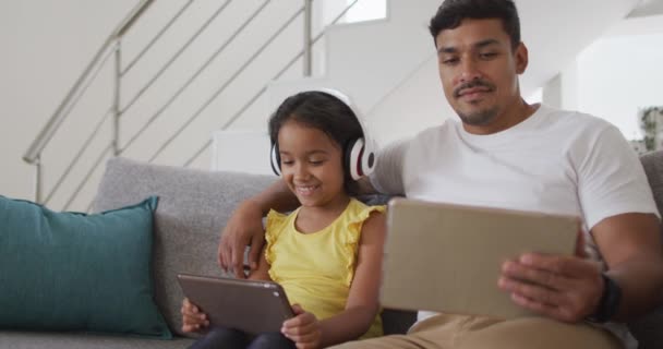 Happy Hispanic Father Daughter Sitting Sofa Using Tablets Home Isolation — Stock Video