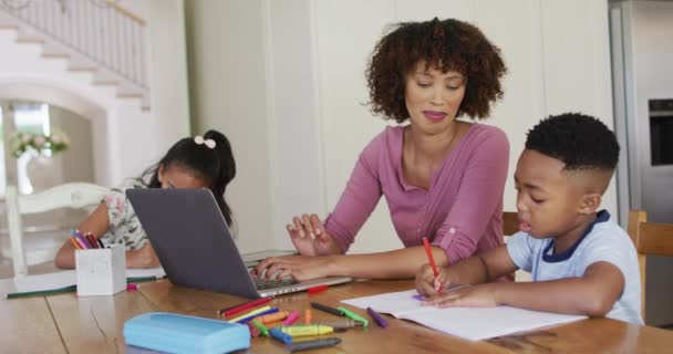 Afroamerikanische Mutter Tochter Und Sohn Sitzen Küchentisch Und Machen Hausaufgaben — Stockvideo