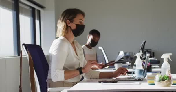 Two Diverse Female Colleagues Wearing Face Mask Working Desk Office — Stock Video