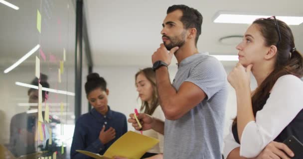 Diverso Grupo Compañeros Trabajo Lluvia Ideas Poniendo Notas Adhesivas Pared — Vídeos de Stock