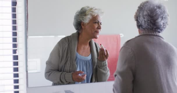 Eine Afroamerikanische Seniorin Trägt Lippenstift Auf Während Sie Hause Den — Stockvideo