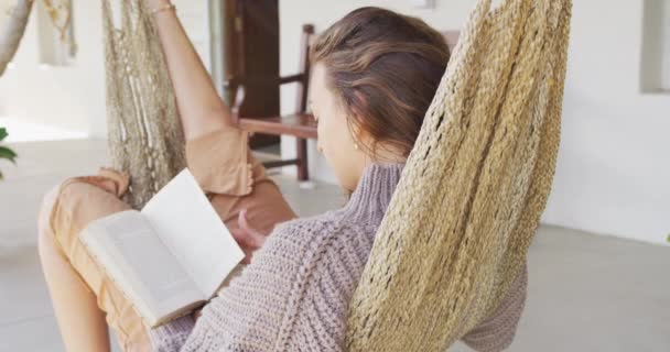 Smiling Caucasian Woman Lying Hammock Reading Book Terrace Healthy Living — Stock Video
