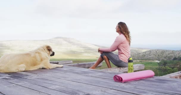 Caucasian Woman Sitting Outdoors Deck Pet Dog Admiring View Rural — Stock Video